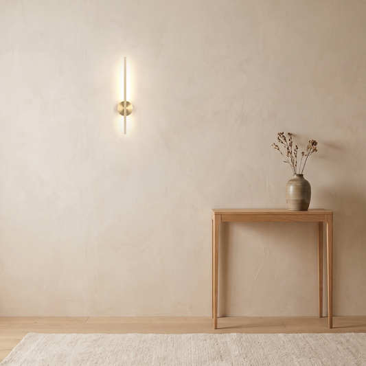 Vela Wall Sconce above a slim oak console table