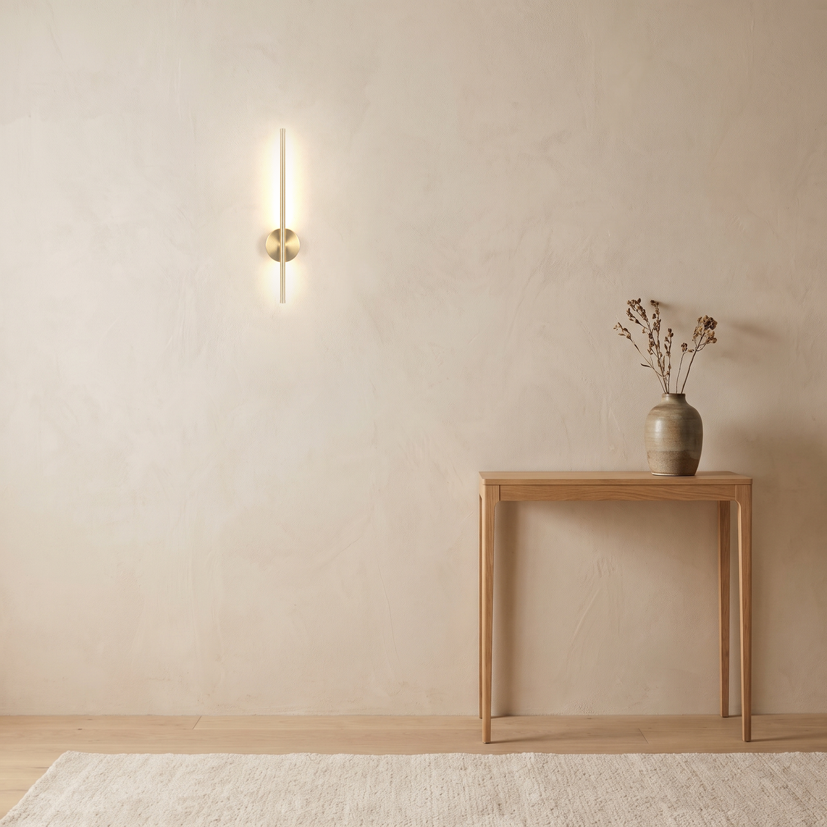 Vela Wall Sconce above a slim oak console table