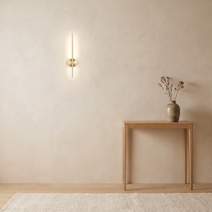 Vela Wall Sconce above a slim oak console table