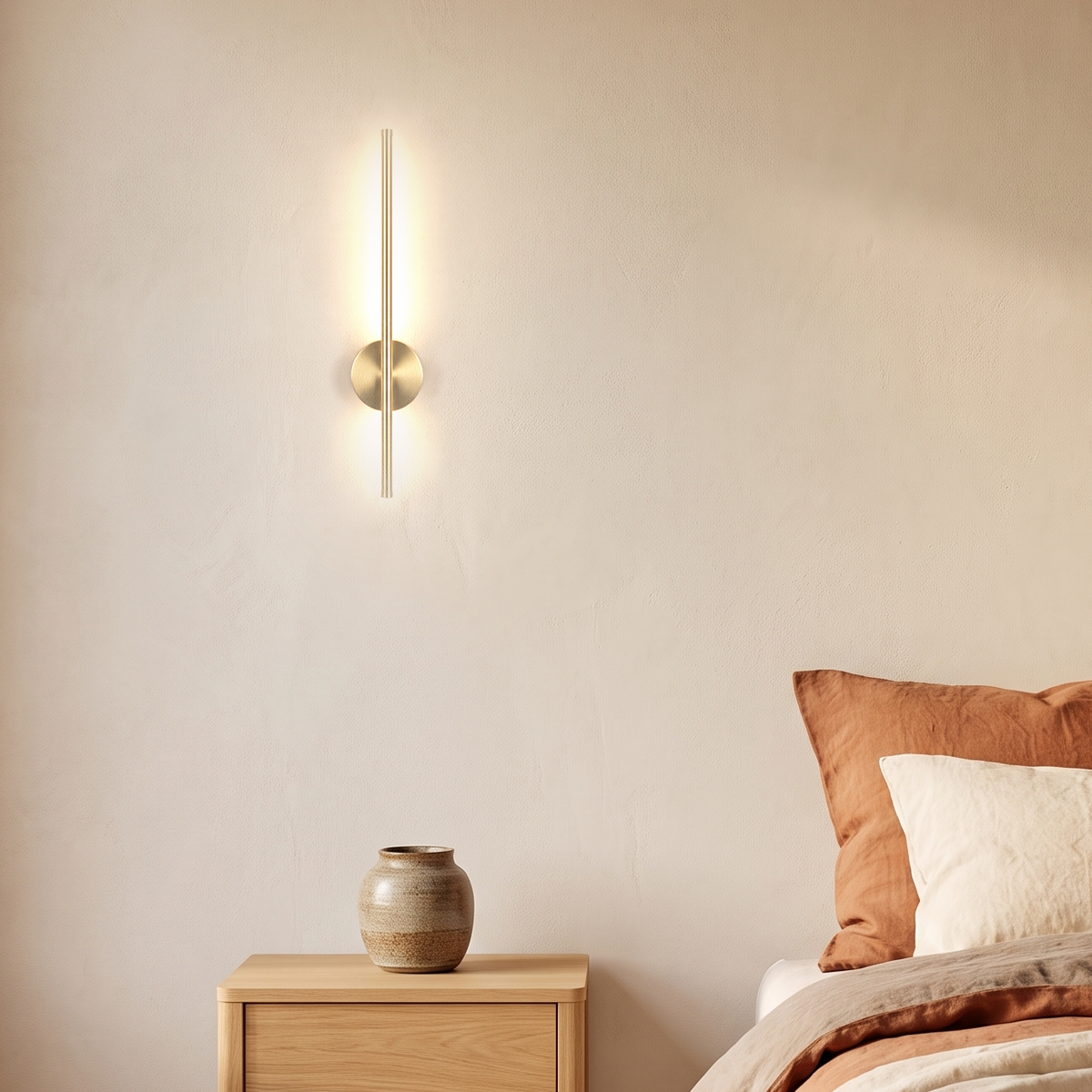 Vela Wall Sconce beside a bed