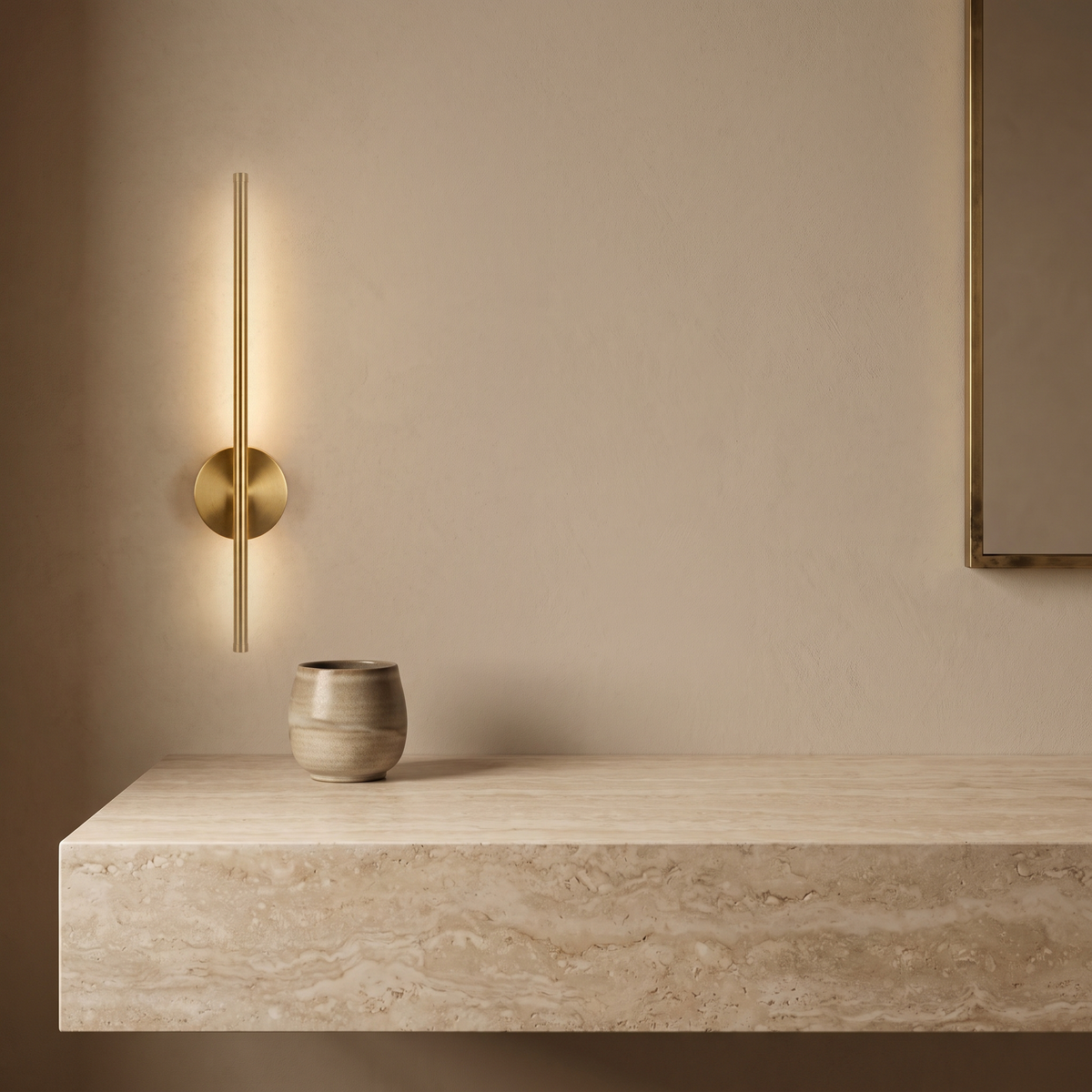 Vela Wall Sconce beside a stone vanity