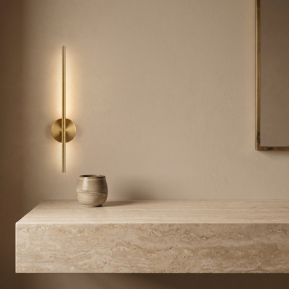 Vela Wall Sconce beside a stone vanity