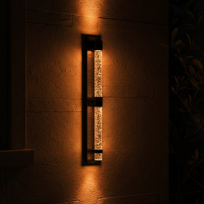 Bastion Outdoor Sconce - glowing at night