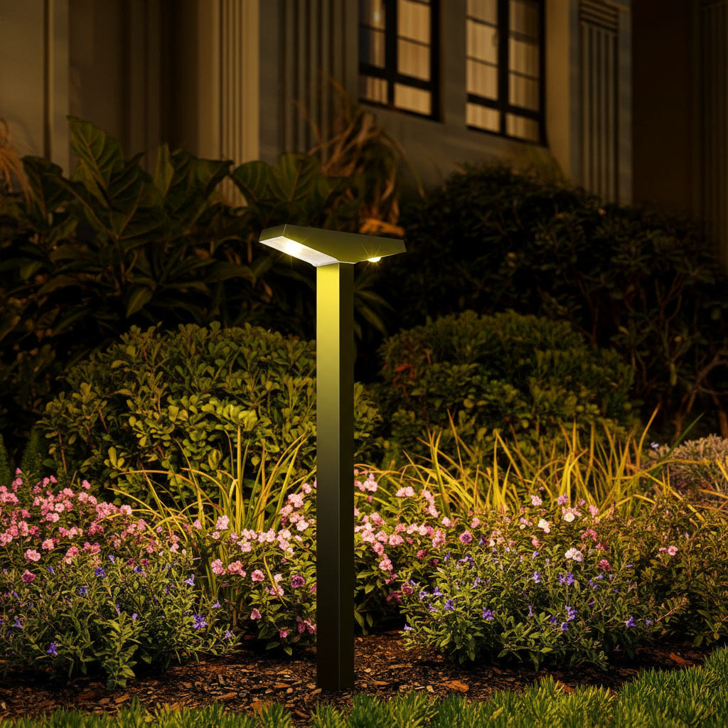 Solene Path Light styled in a garden border