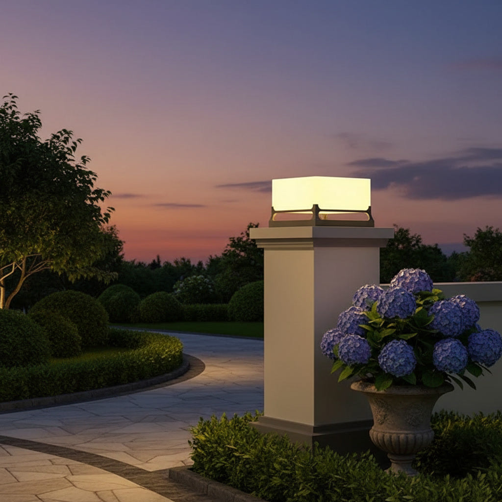 Polaris Pillar Light styled on a garden gate pillar at dusk