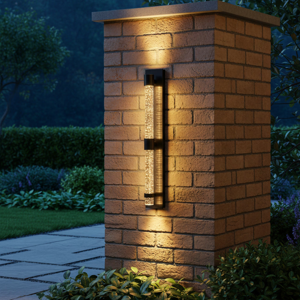 Bastion Outdoor Sconce styled on a garden pillar at dusk