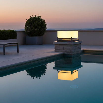 Polaris Pillar Light styled by a poolside at dusk