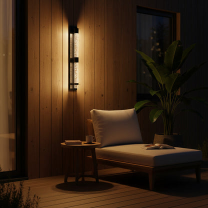 Bastion Outdoor Sconce styled on a covered patio at night