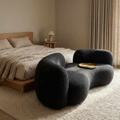 Luca curved sofa styled in a bedroom