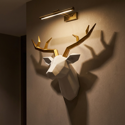 Stag stag head wall sculpture, lit at night